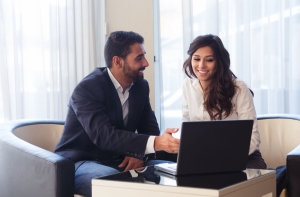 Young business couple with a laptop