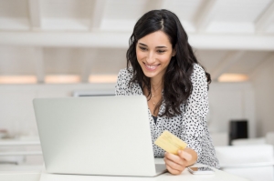 Woman on laptop with debit card