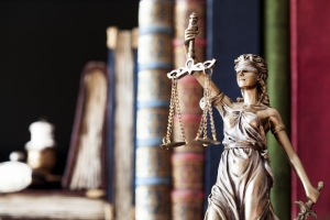 Statue of Lady Justice with legal books