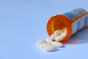 Prescription pills and bottle on a blue background